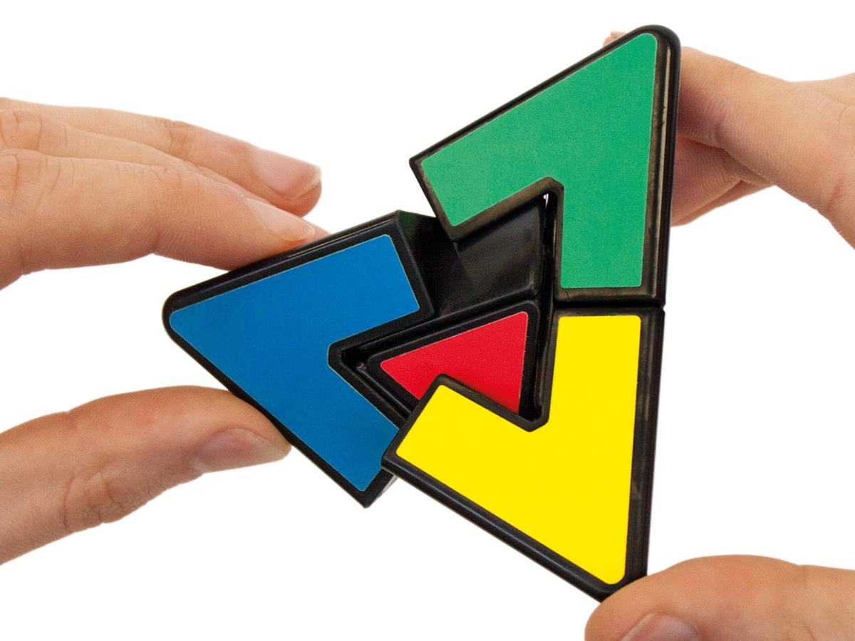 Hands moving the parts of a pyramid-shaped puzzle.