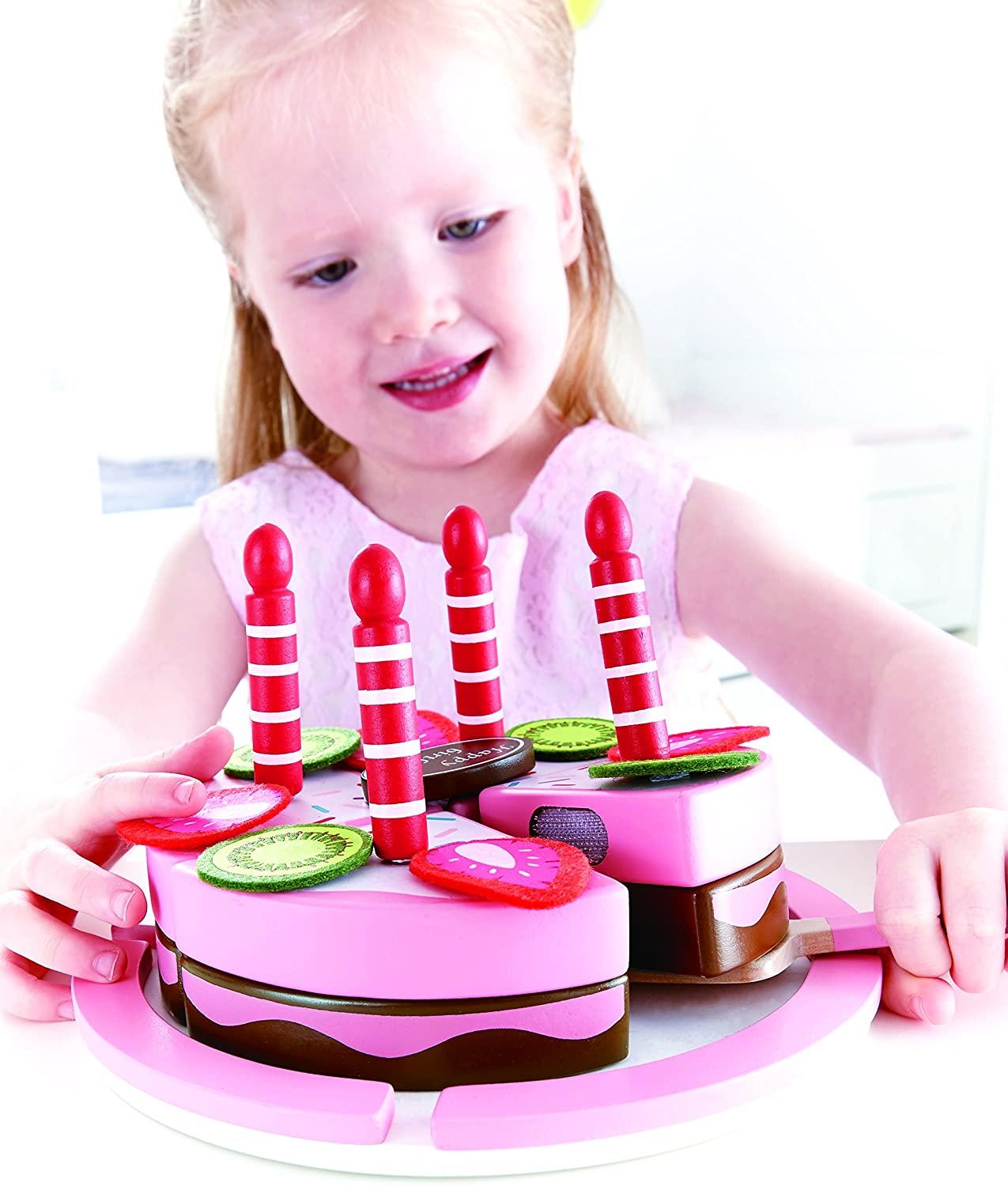 Girl playing with Birthday cake pieces
