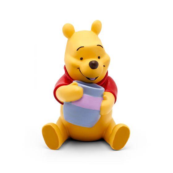 Yellow Winnie The Pooh wearing a red top and sitting with a blue pot of honey.