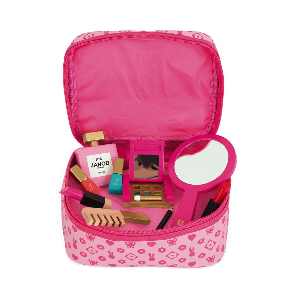 Children's pink play vanity case opened to show the different wooden pieces inside.