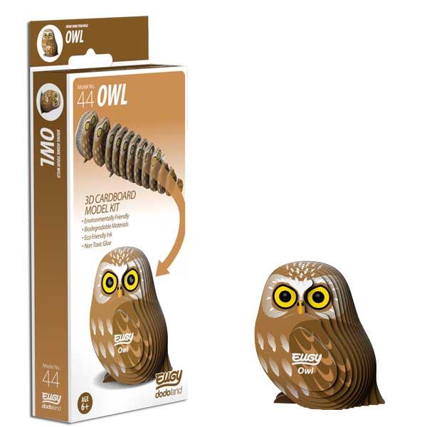 Brown Eugy owl figure beside box.