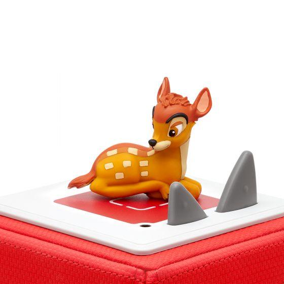 Bambi lying down on top of red Toniebox.