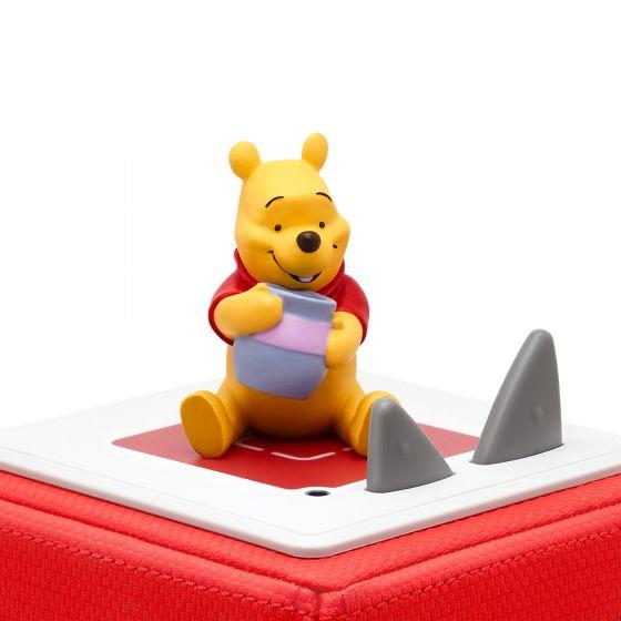 Winnie The Pooh character sitting on top of the red Toniebox.