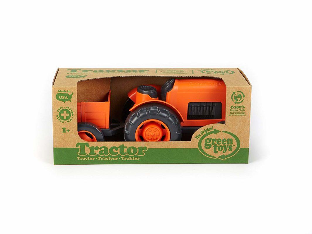 Orange tractor and trailer in manufacturer's packaging.
