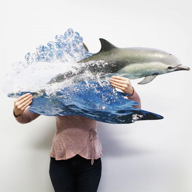 Person holding large dolphin jigsaw puzzle.