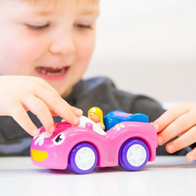 Child playing with car and doll set.