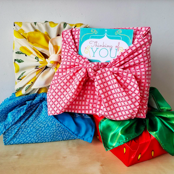 Different, bright pieces of material knotted and used as gift wrapping.