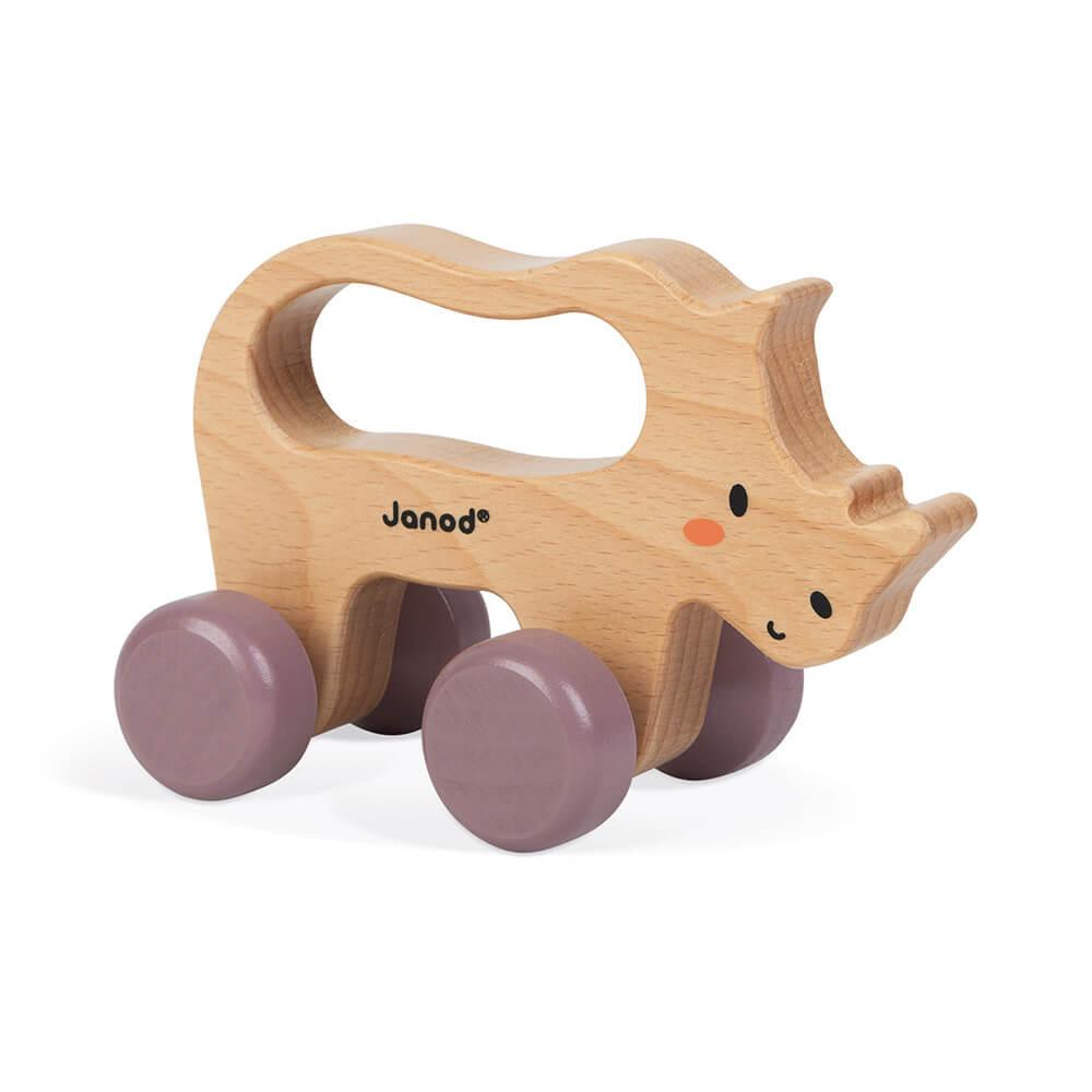 Wooden toy rhino to push along ona  white background.