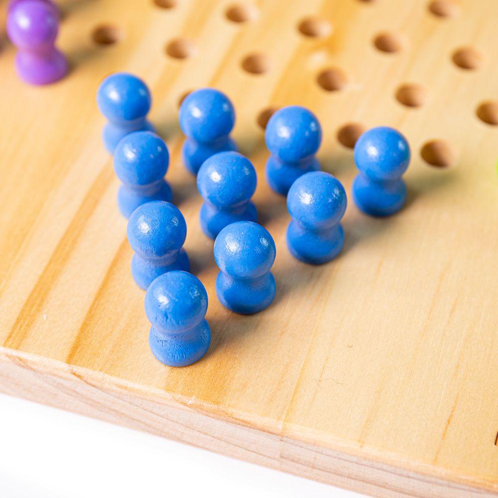 Close up of the 10 blue pegs in the corner of the star of the Chines Chequers game.