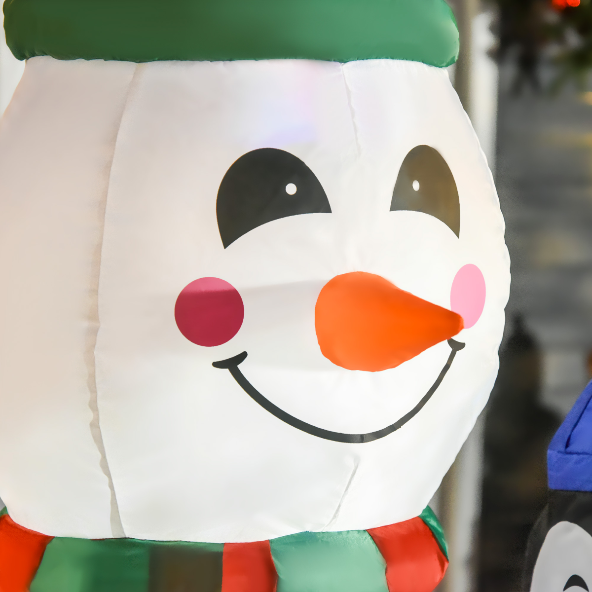 Close-up picture of 6ft Inflatable Christmas Snowman with Three Penguins LED Outdoor Yard Deco on a clean background.