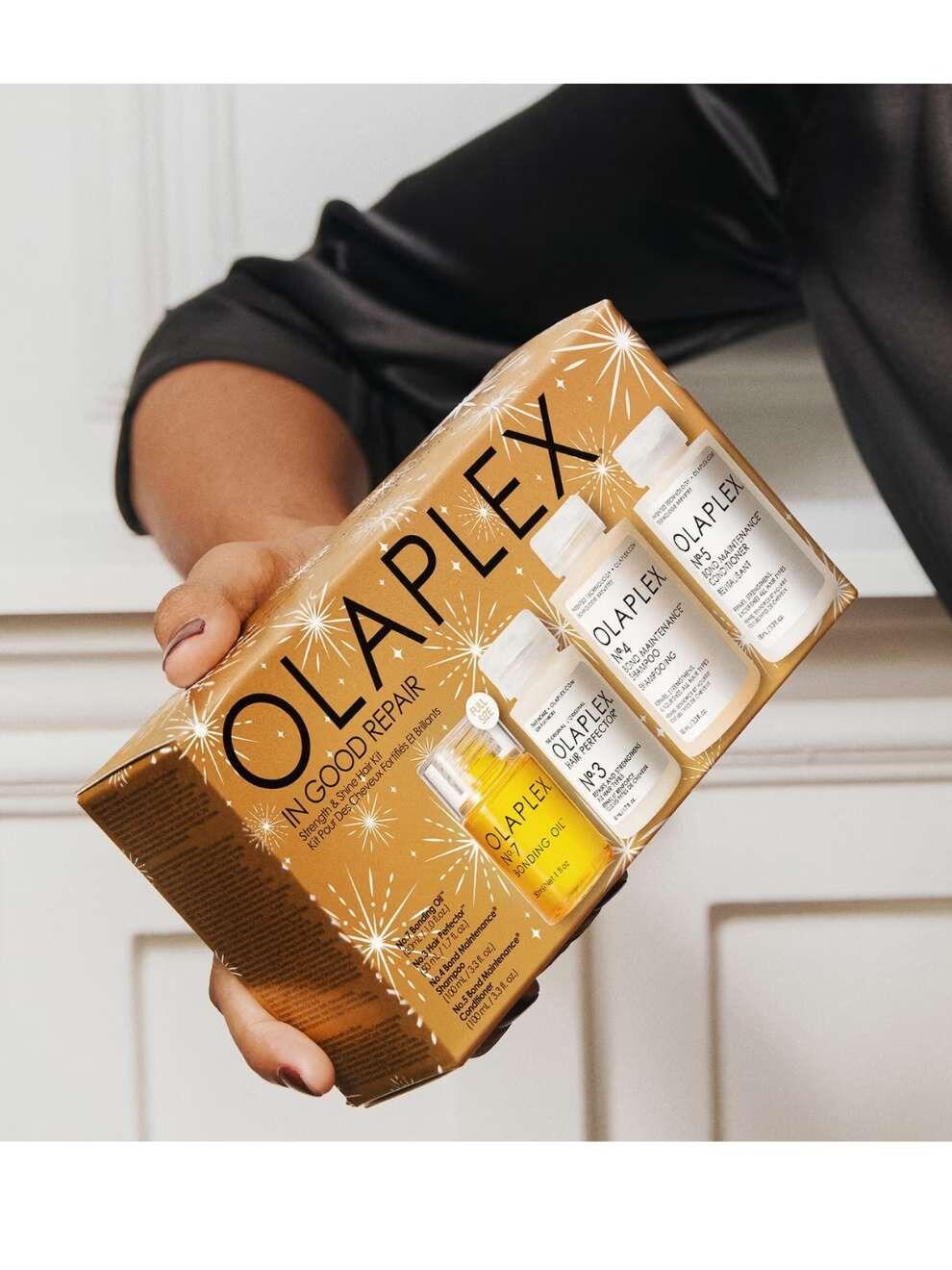 Olaplex In Good Repair Christmas 2024 Hair Kit (Worth £67) Woman holding the product