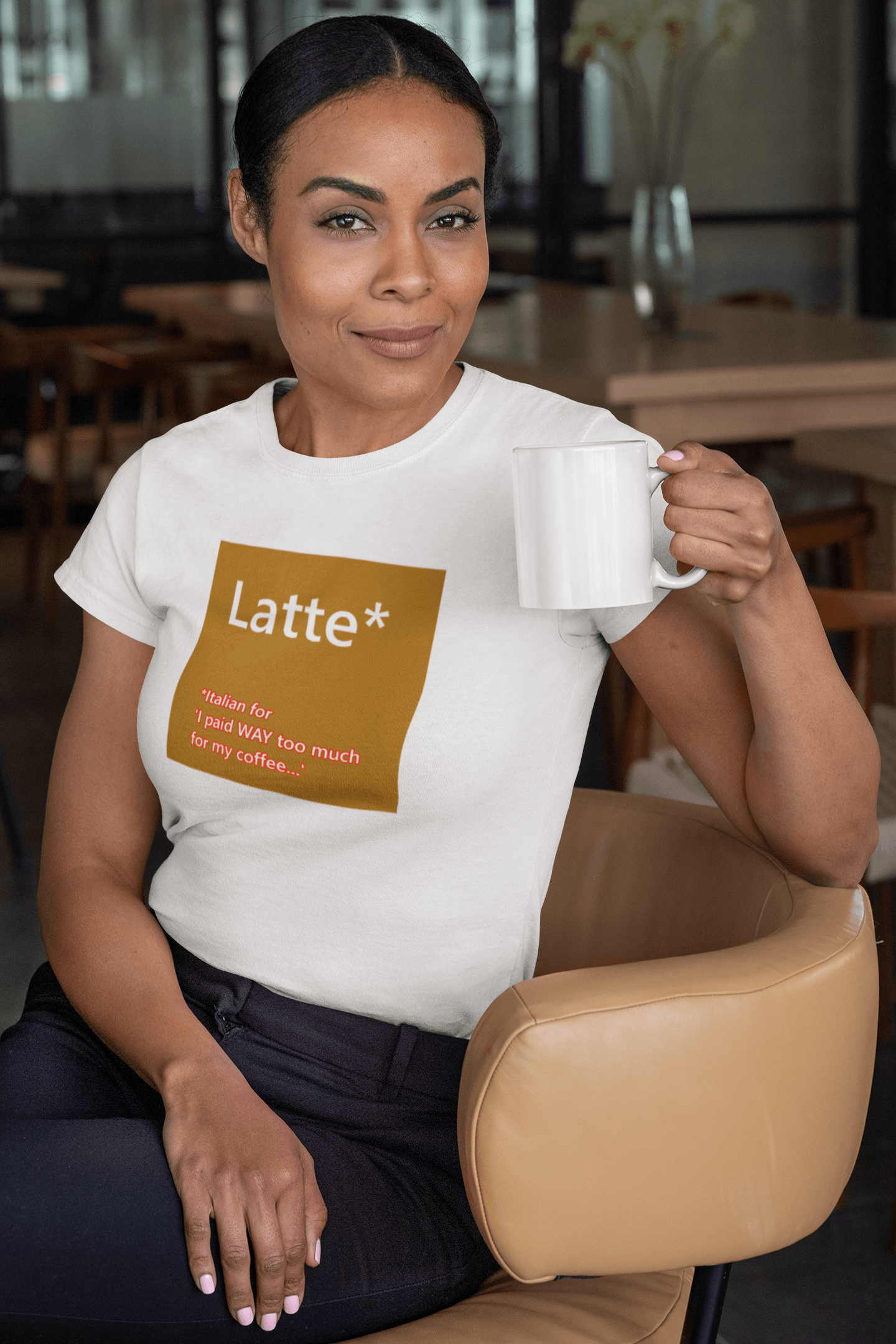 ladt drinking coffee and wearing a slogan t-shirt