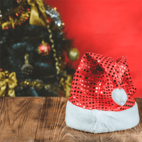 santa hat and christmas tree on red background