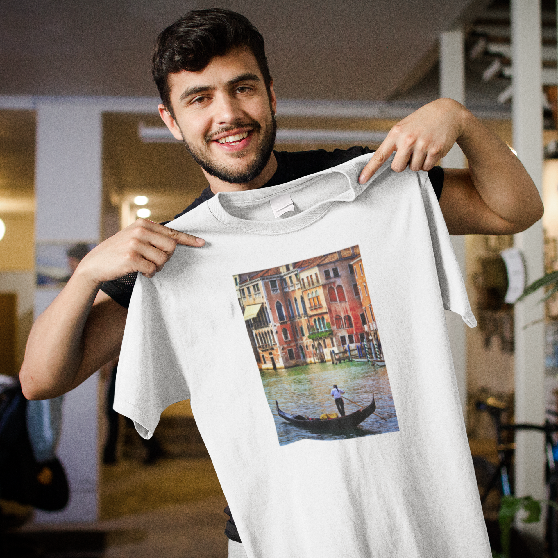 man holding a personalised t shirt with a picture on the chest