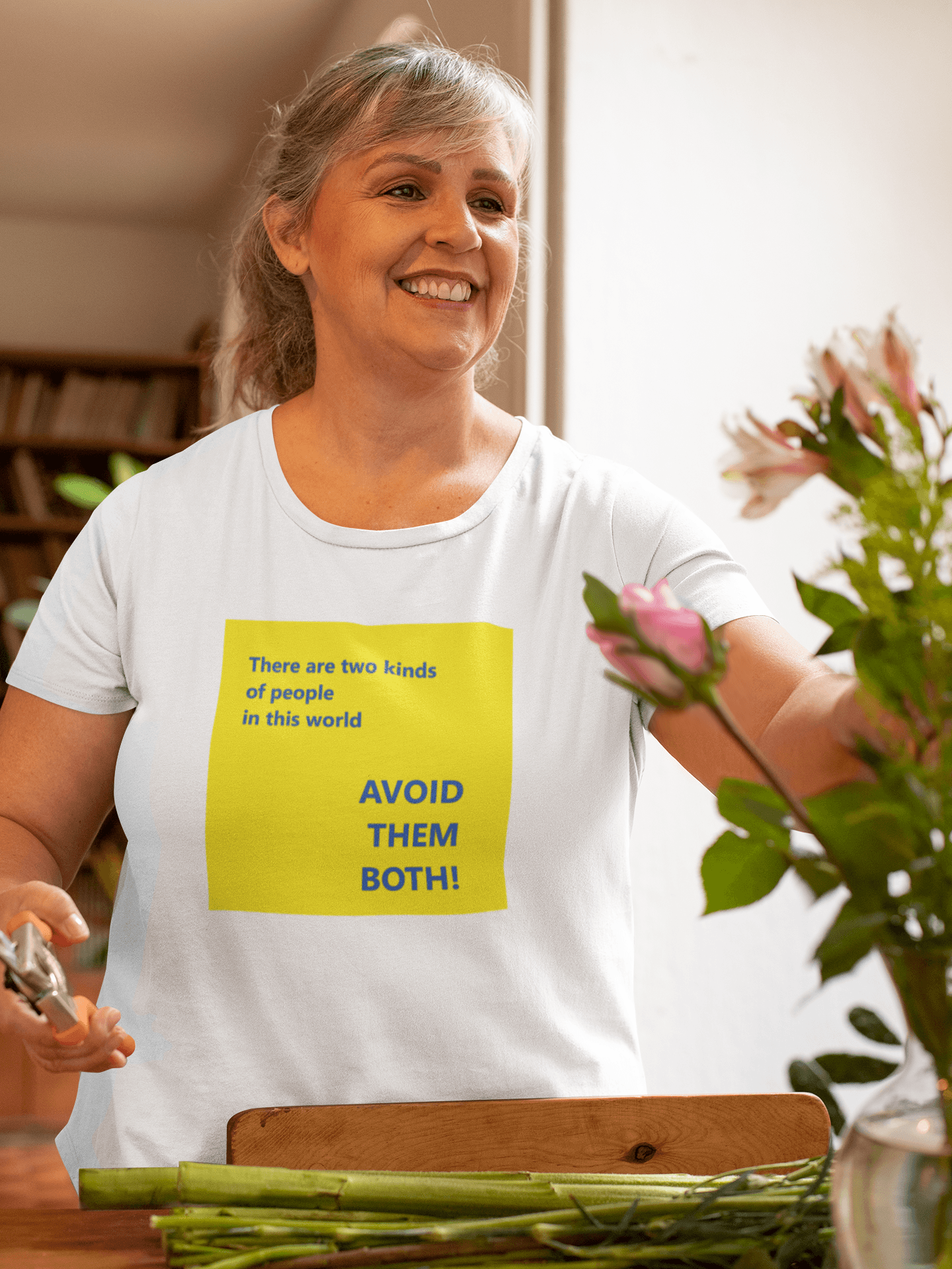 woman watering plants wearing a slogan t shirt