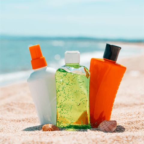 bottles of suntan lotion on a beach