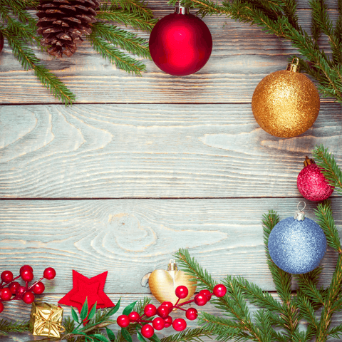 christmas baubles and berries on a wooden background
