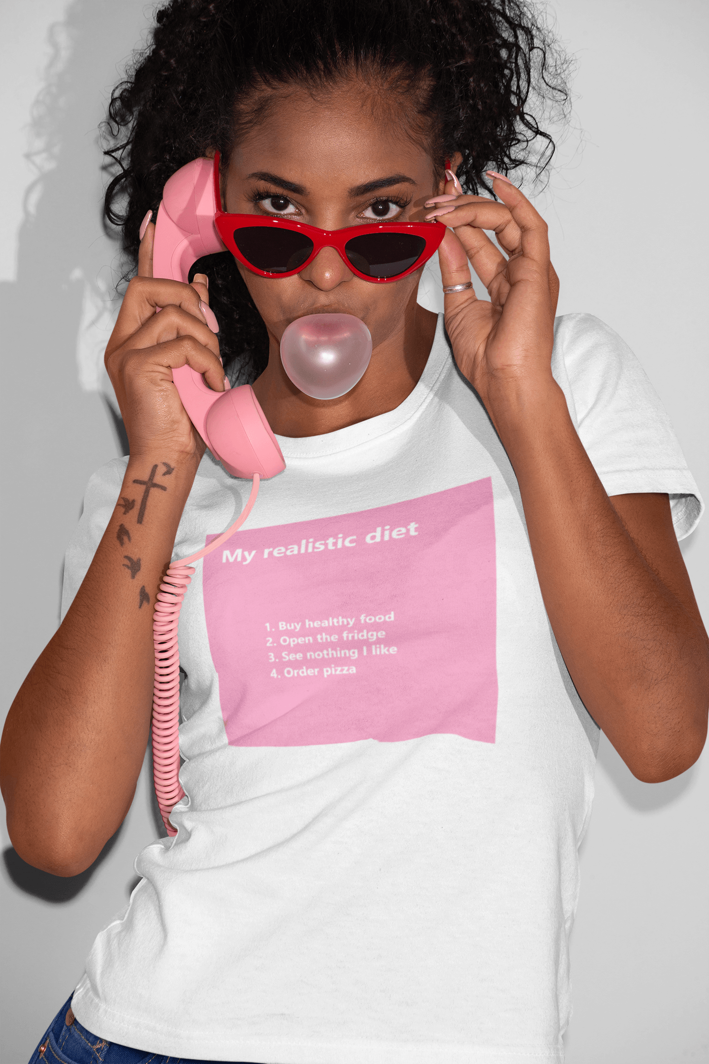 girl wearing a slogan t-shirt on the telephone blowing gum