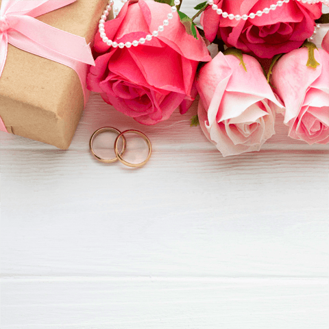 pink roses and wedding rings