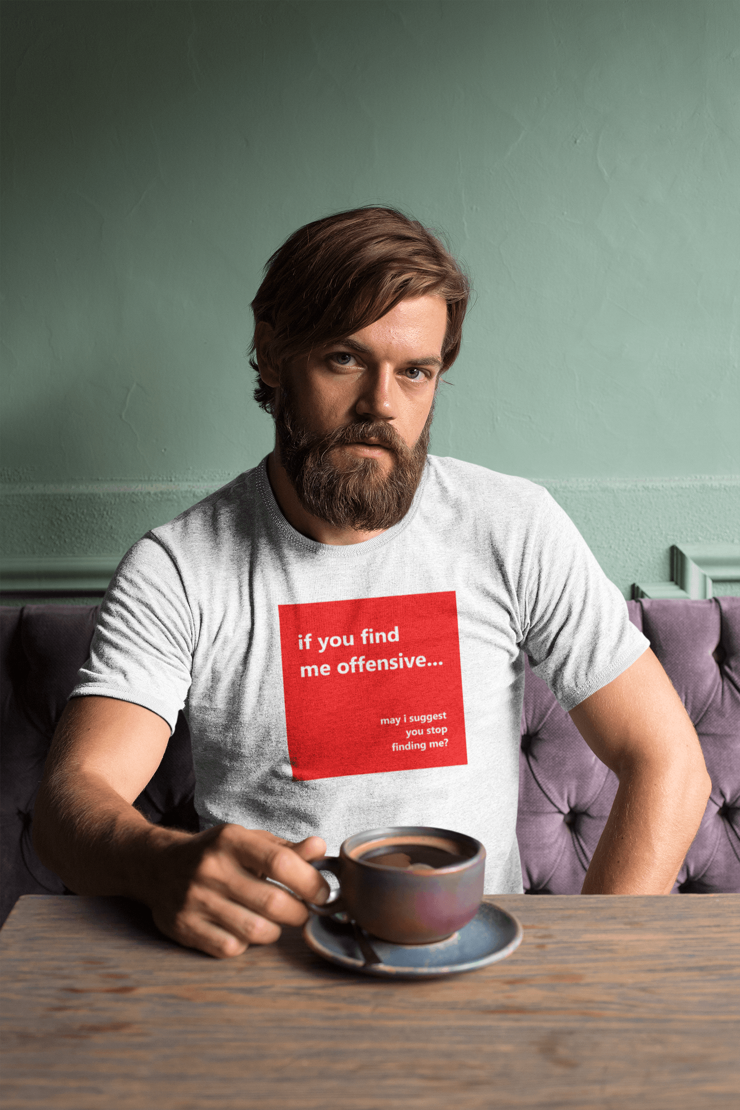 berded man with a coffee wearing a slogan t-shirt