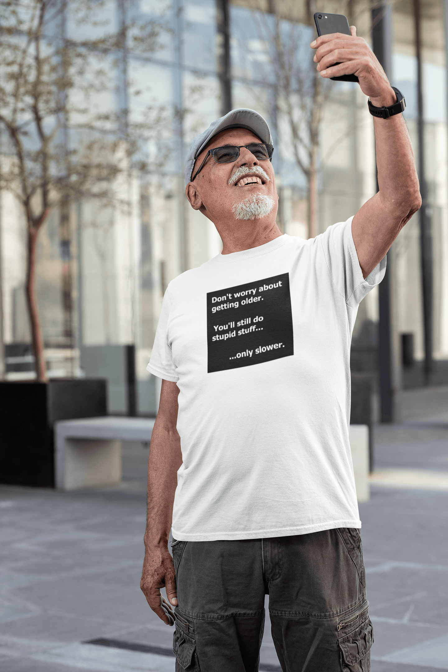 senior man taking selfie wearing slogan t-shirt