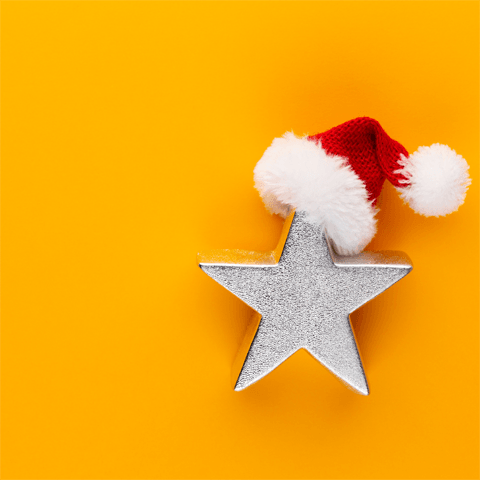 silver star and christmas hat on yellow background