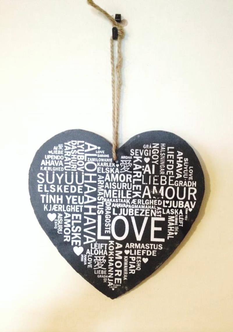 Heart shaped slate sign with 'Love' in many languages written all over.