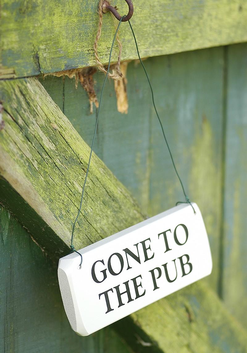 Small painted wooden rectangular sign bearing the words "Gone to the pub".
