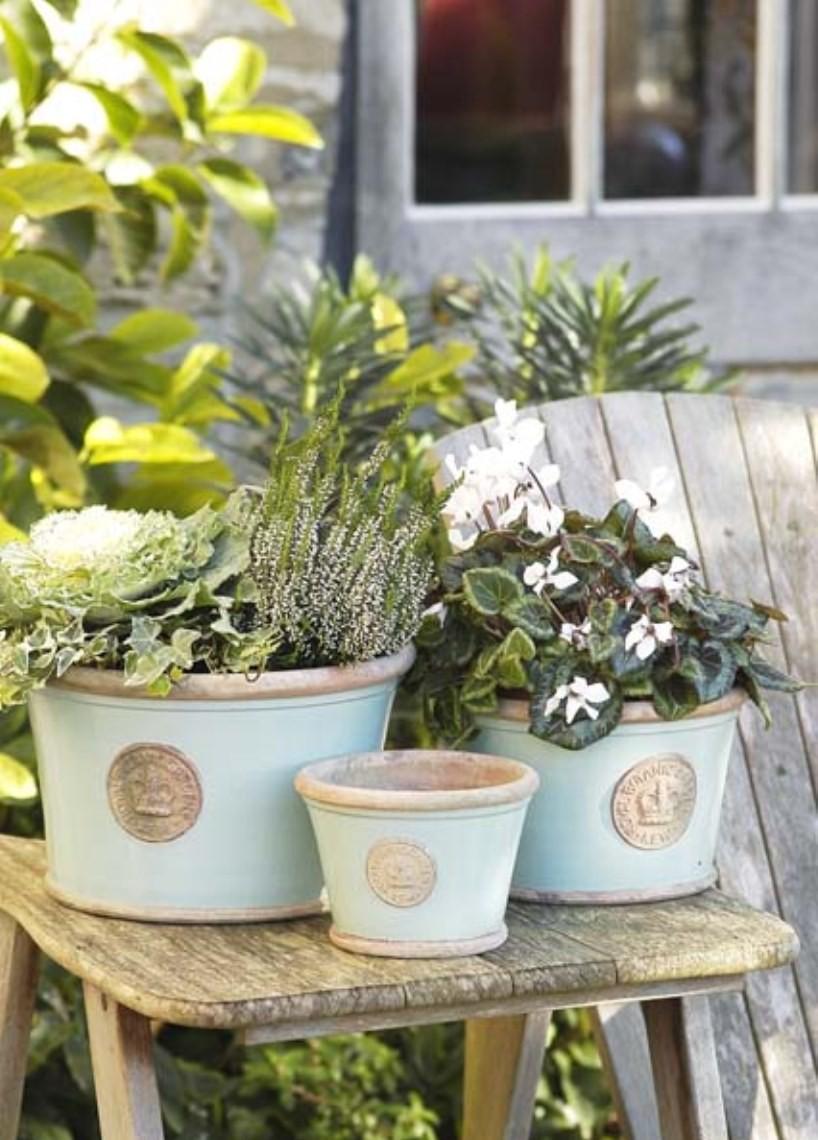 A collection of three Kew Low Planters in Tiffany Blue planted with a selection of plants