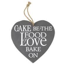 Heart shaped slate with twine string for hanging with the inscription "If cake be the food of Love, Bake On"
