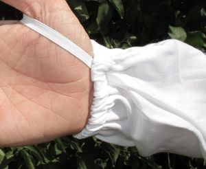 Hand of man in White Fencing Veil Beekeeping Suit