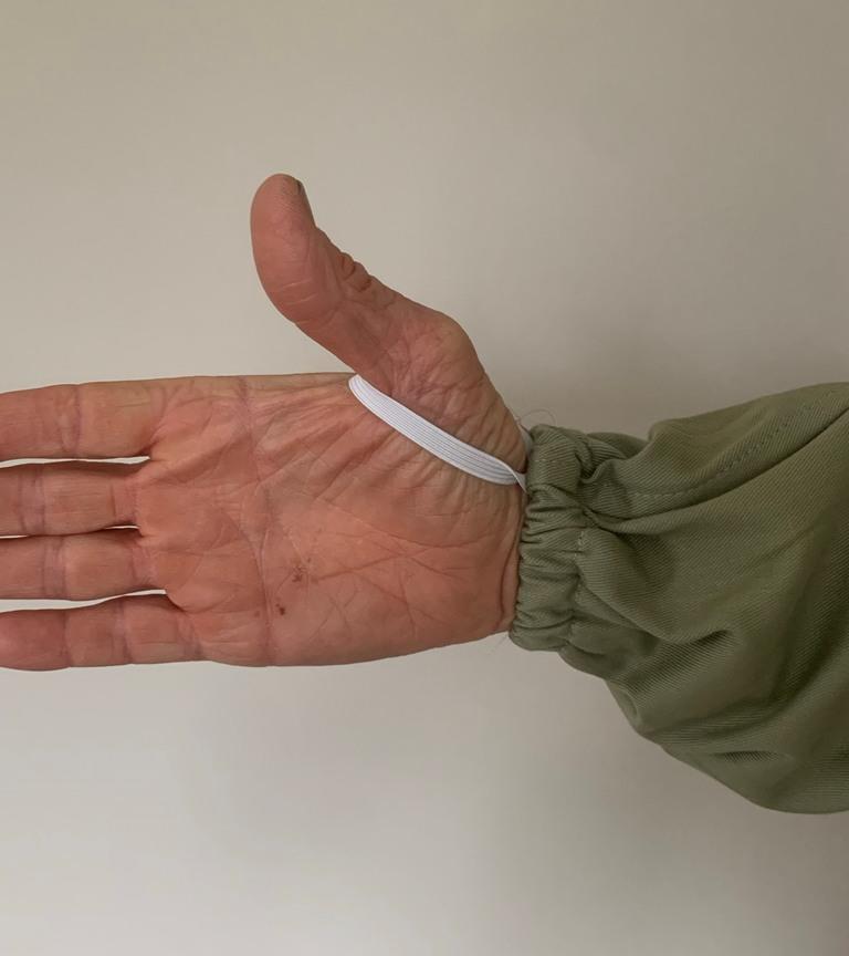 Hand of Man in Olive Fencing Veil Beekeeping Suit