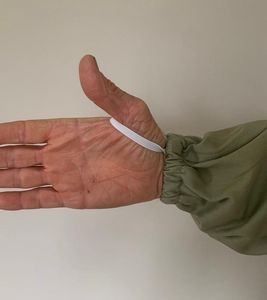 Hand of Man in Olive Fencing Veil Beekeeping Suit