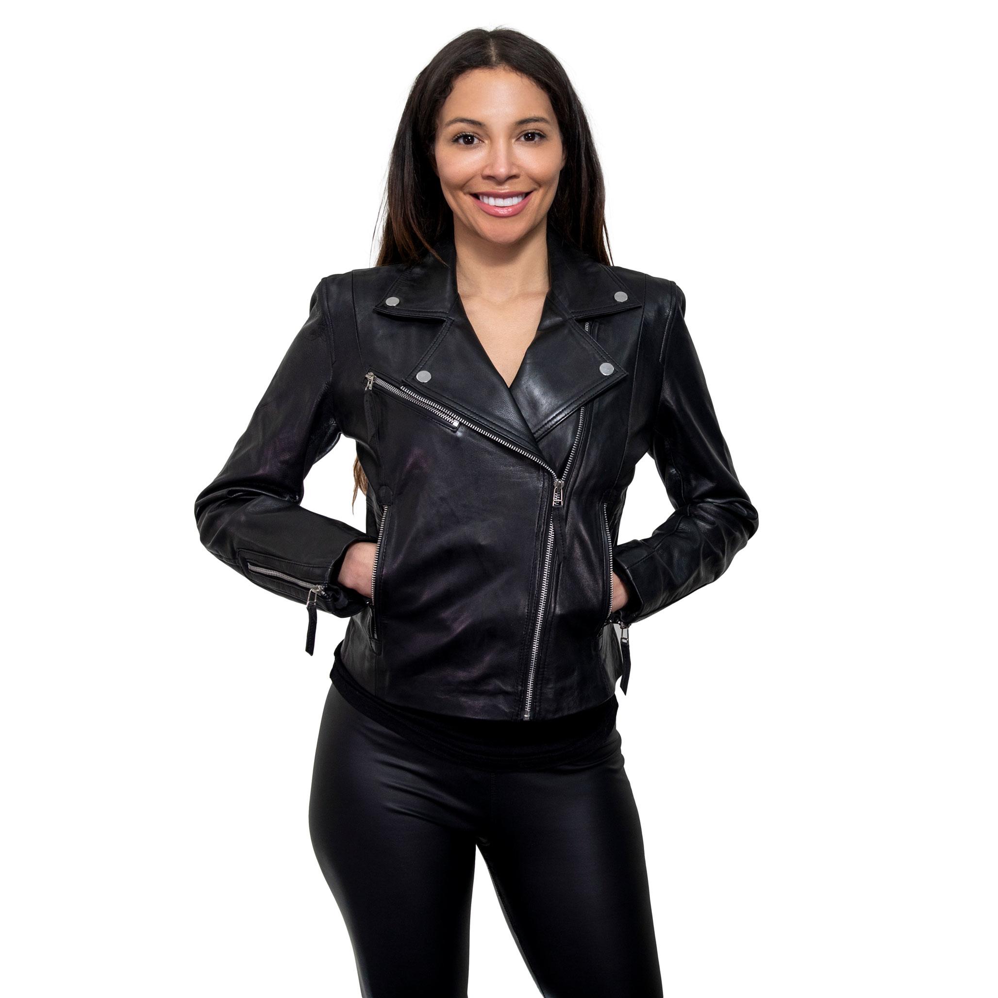 A model smiling with her hands in her pockets, wearing a wonderful womens black biker jacket, in a slim fit.
