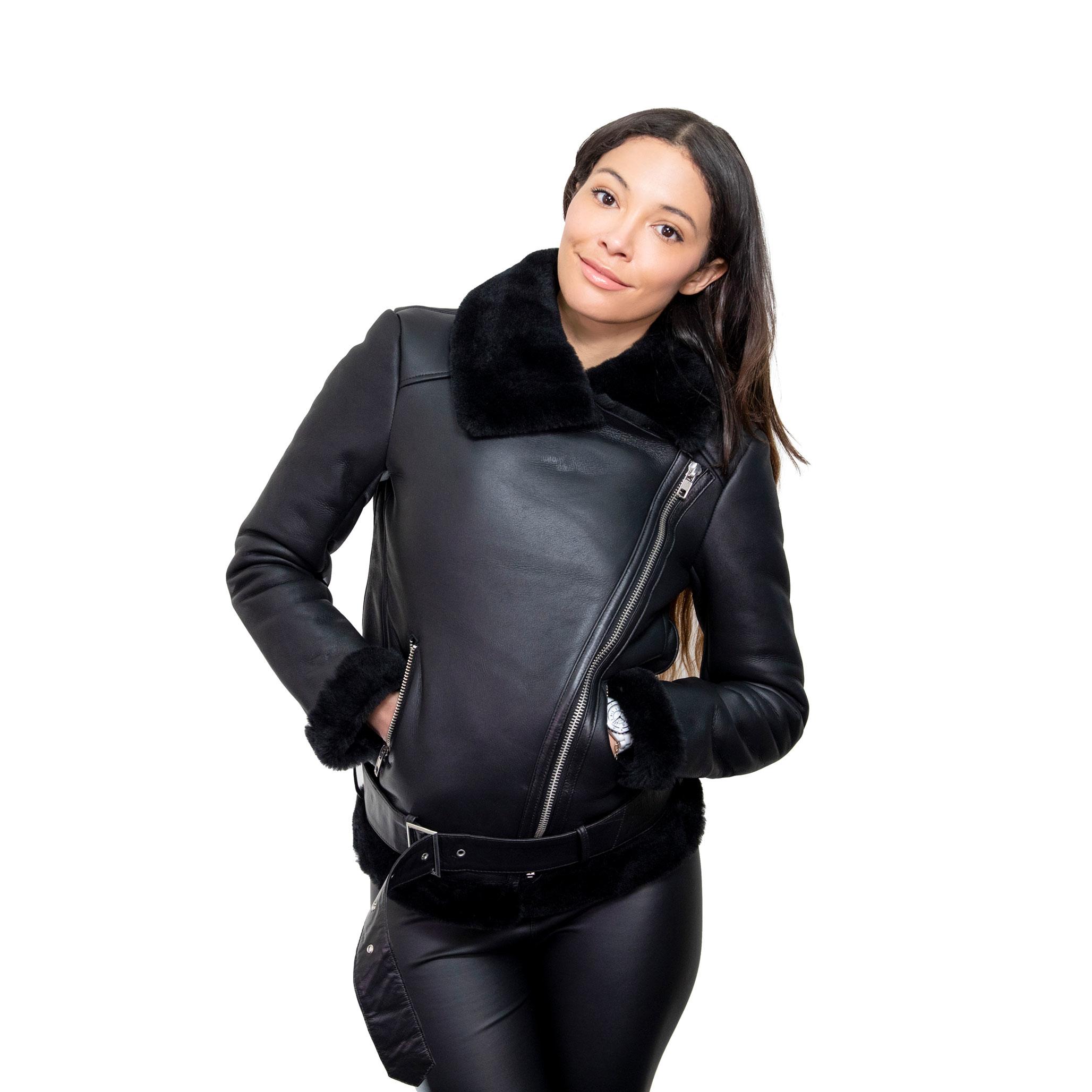 A model wearing a beautiful, sleek sheepskin jacket, with a leather outer finish, and thick inner fur. The Cuffs, and hem have been lined with fur also. Asymmetrical front zip fastening.
