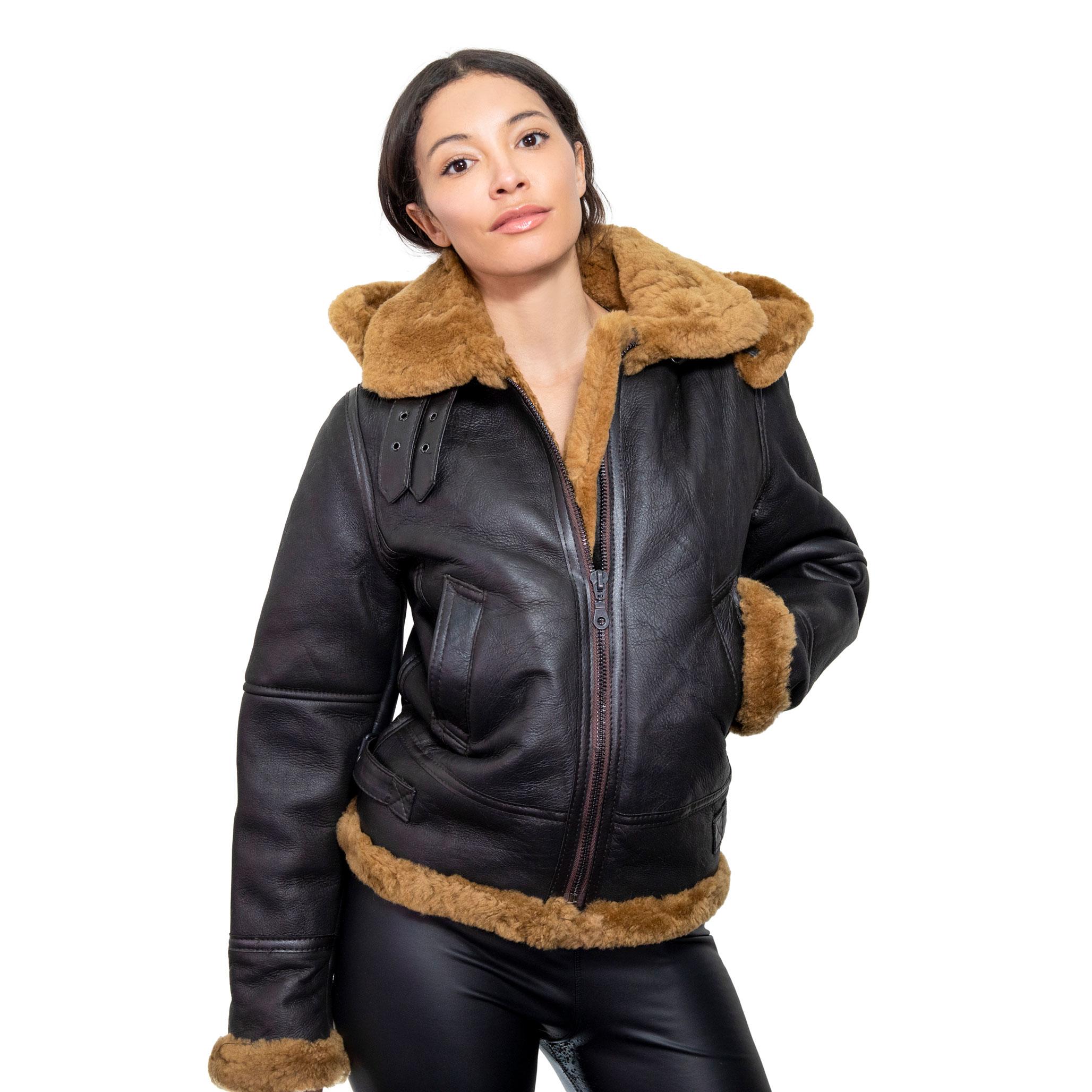 A female model wearing a hooded brown sheepskin jacket, with lush ginger inner fur.