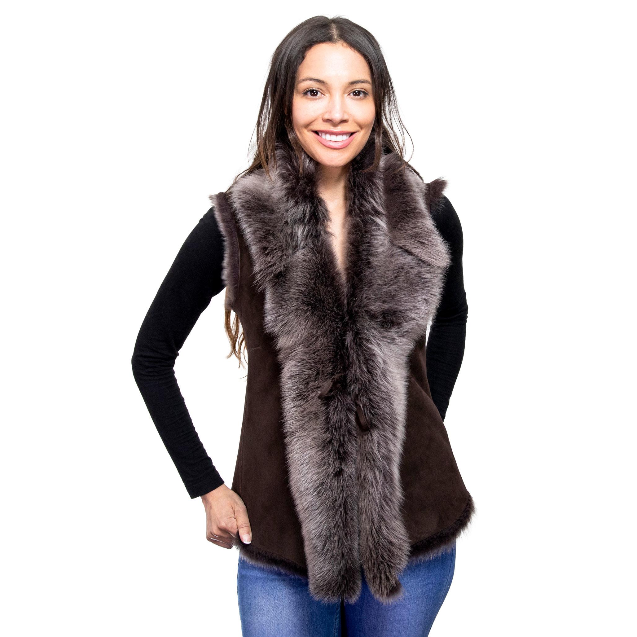 A model wears a beautiful, luxe brown sheepskin gilet, with a sued outer finish. Draped in lush Toscana fur.