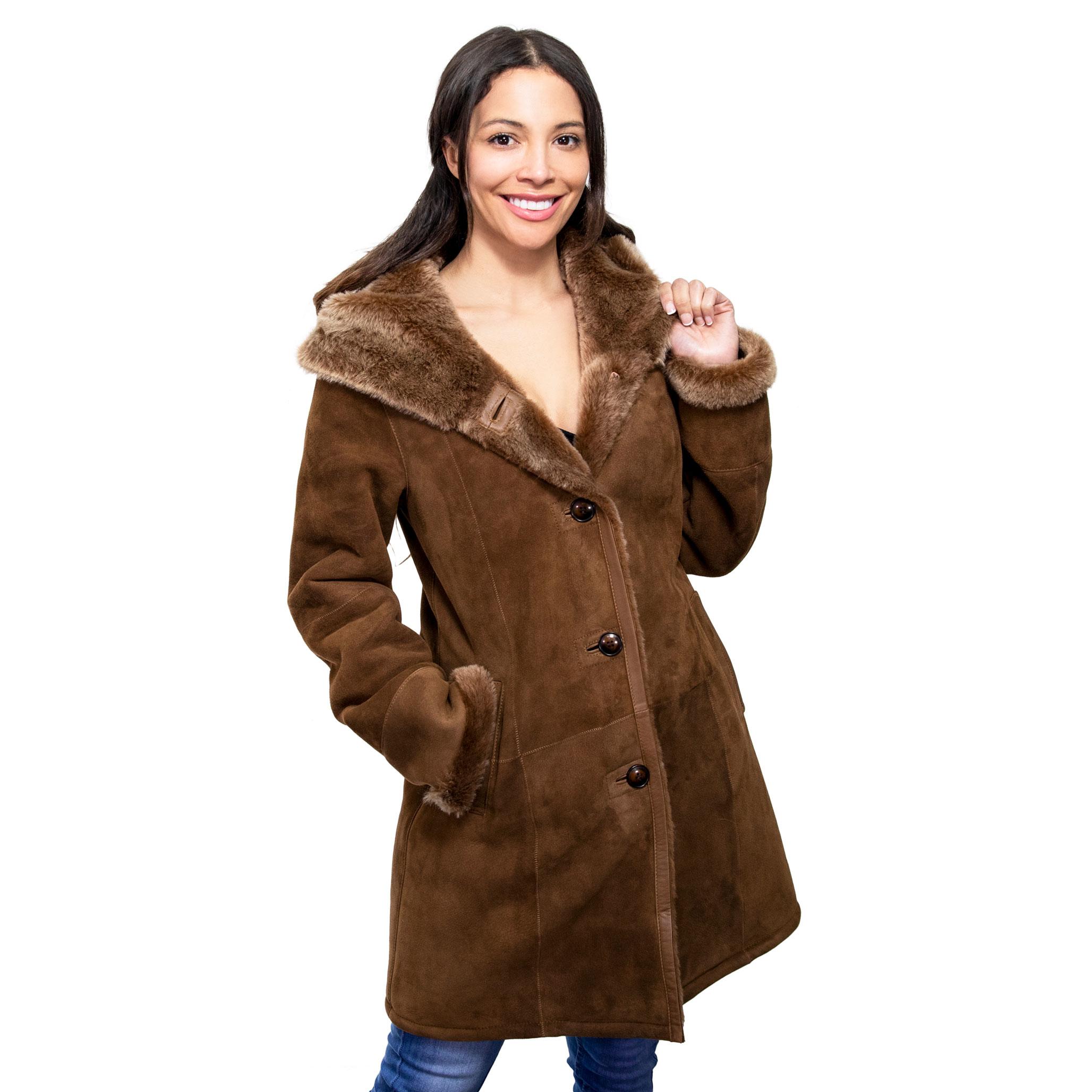 The model looks so delighted wearing a tan sheepskin coat, in a suede finish. The coat is hooded, with front buttoned fastening, with long, comfortable sleeves.