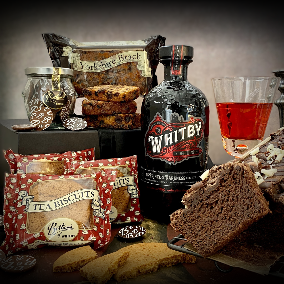 Botham's of Whitby Vampire Selection with The Prince of Darkness Edition Whitby Gin, featuring Belgian Chocolate Cake, Yorkshire Brack, twin pack Tea Biscuits and Chocolate 'B' Buttons. A horrifyingly delicious and alternative gift from Botham's iconic Whitby bakery.