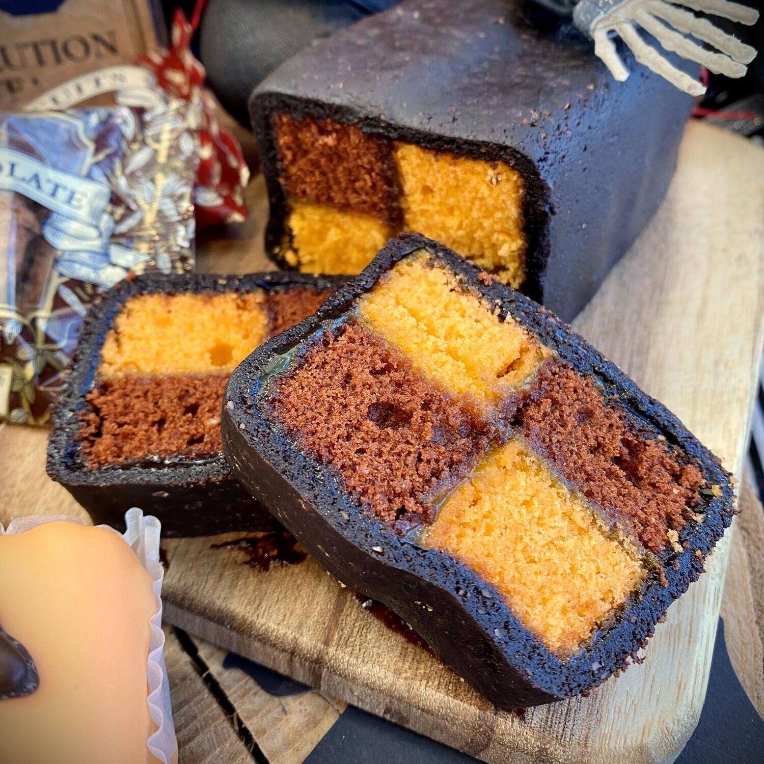 Botham's of Whitby Chocolate Orange Battenburg with an orange and chocolate genoise sponge chequerboard, sandwiched with Lemon Curd and encased in gothic black Almond Paste. A delicious and spooky Halloween bake from Botham's iconic Whitby bakery.