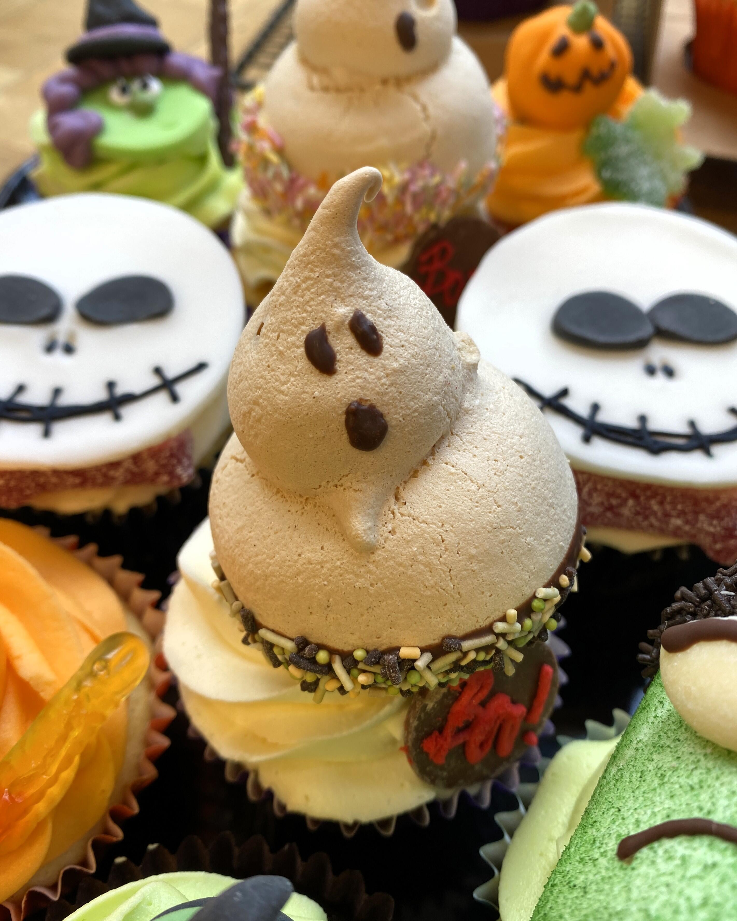 Botham's of Whitby shop tray full of Halloween cupcakes and fondant fancies, hand-decorated for Halloween characters such as witches, ghosts, Frankenstein and pumpkins. Unique Halloween cakes from Botham's iconic Whitby bakery.