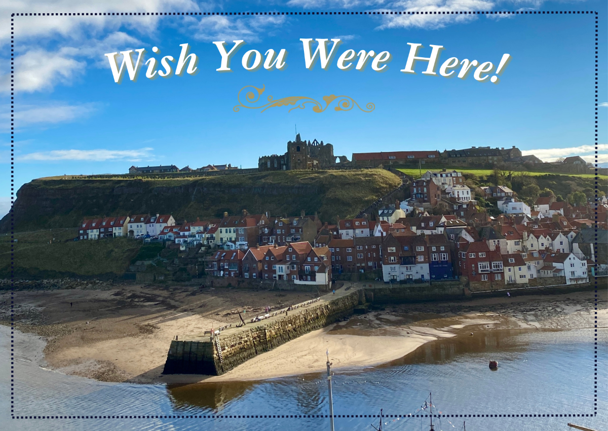 Postcard from Whitby featuring an iconic photograph of Whitby's east cliff with St Mary's Church and Whitby Abbey standing tall, and the harbour. Text reads 'Wish You Were Here!'