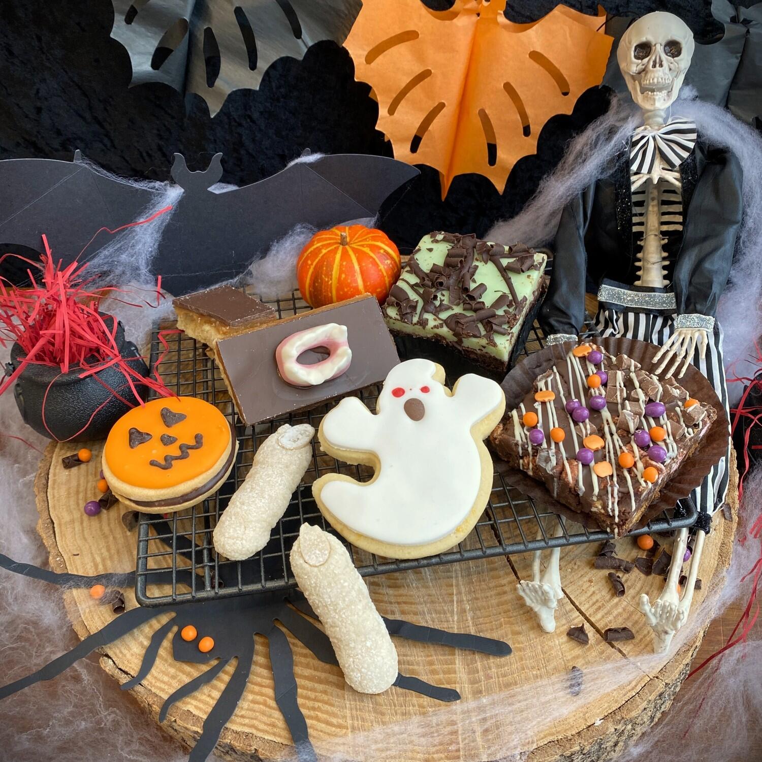 Botham's of Whitby Ghastly Ghouls Cake Club which is a letterbox sized hamper containing seven spooky small cakes from Botham's iconic Whitby bakery, including Witches' Fingers, Jack-O-Lantern Button Moon, Fang Caramel Apollo, Novelty Ghost Biscuit and Goblin's Peppermint Brownie.