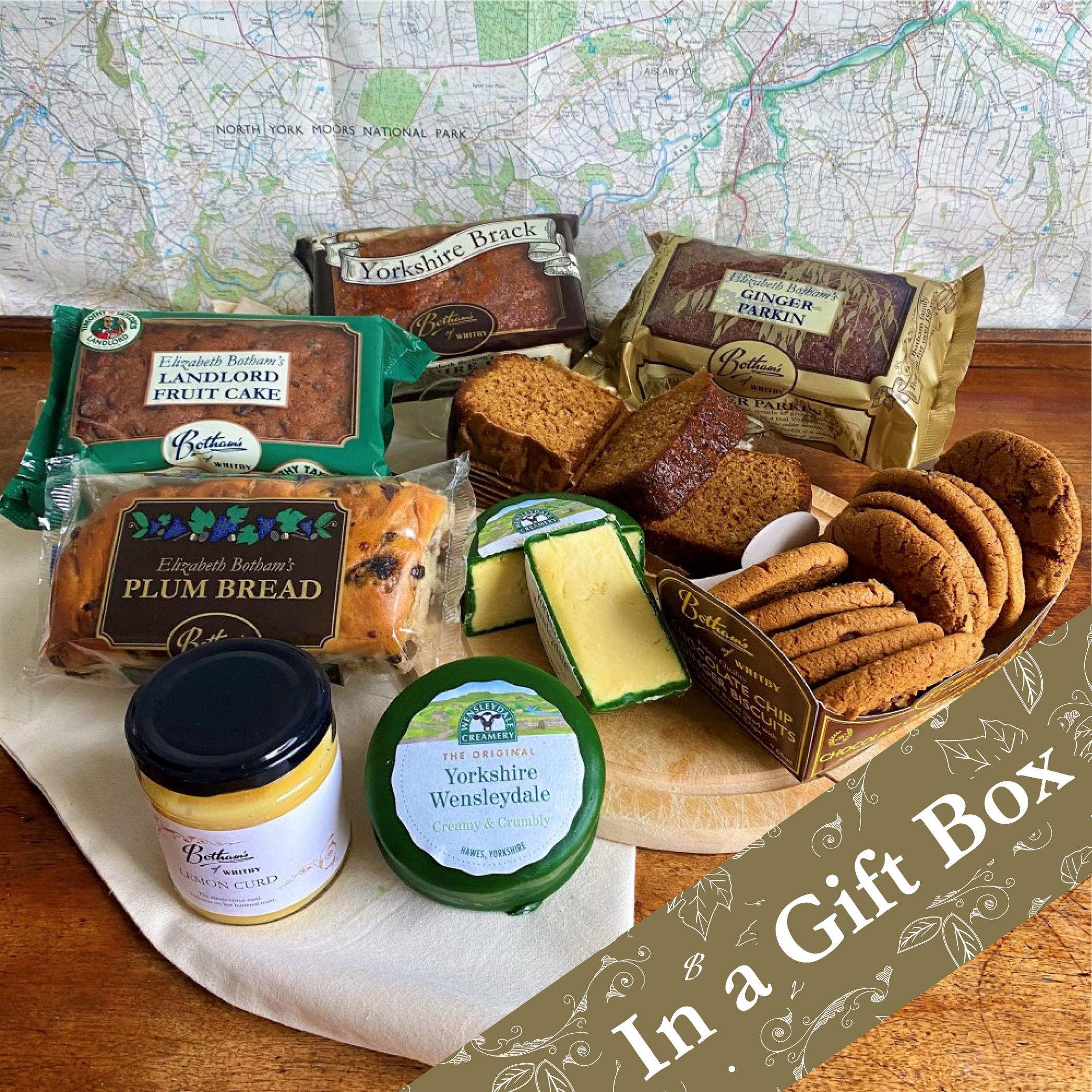 Image displays content of Dales Hamper, including: Yorkshire Brack Plum Bread Yorkshire Ginger Parkin Landlord Fruit Cake Chocolate Chip & Ginger Biscuits Yorkshire Wensleydale Cheese Lemon Curd Botham's of Whitby Cotton Bag. Map of the Yorkshire Dales is displayed in the background.