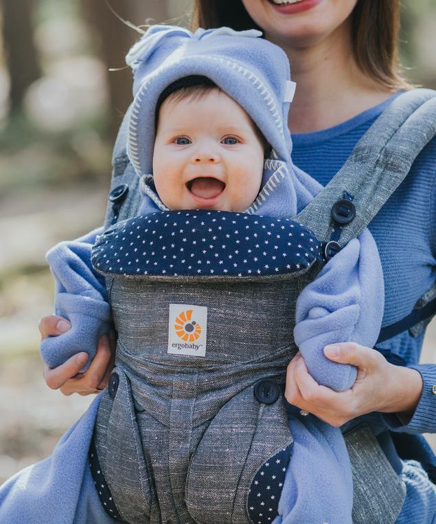 George wears cornflower star baby wrap in baby carrier