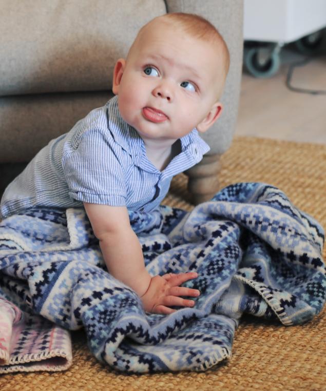 baby boy with blue fairisle baby blanket in lambswool by Tuppence and Crumble