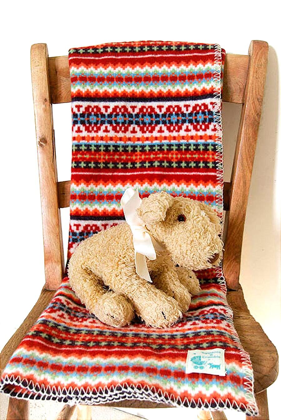 Red Fairisle Baby Blanket on chair with toy by Tuppence and Crumble