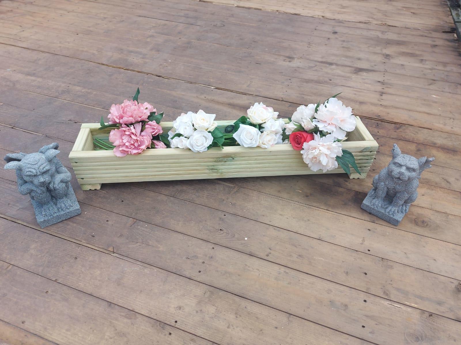 decking planter with statues each side on a decking base