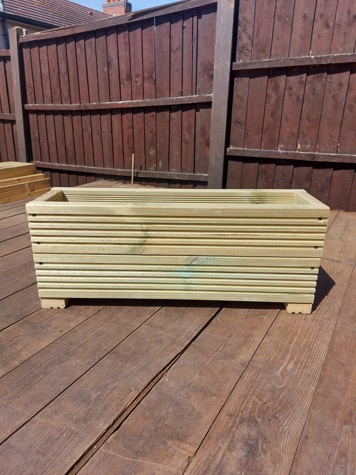 decking planter with fence in the background on a decked base