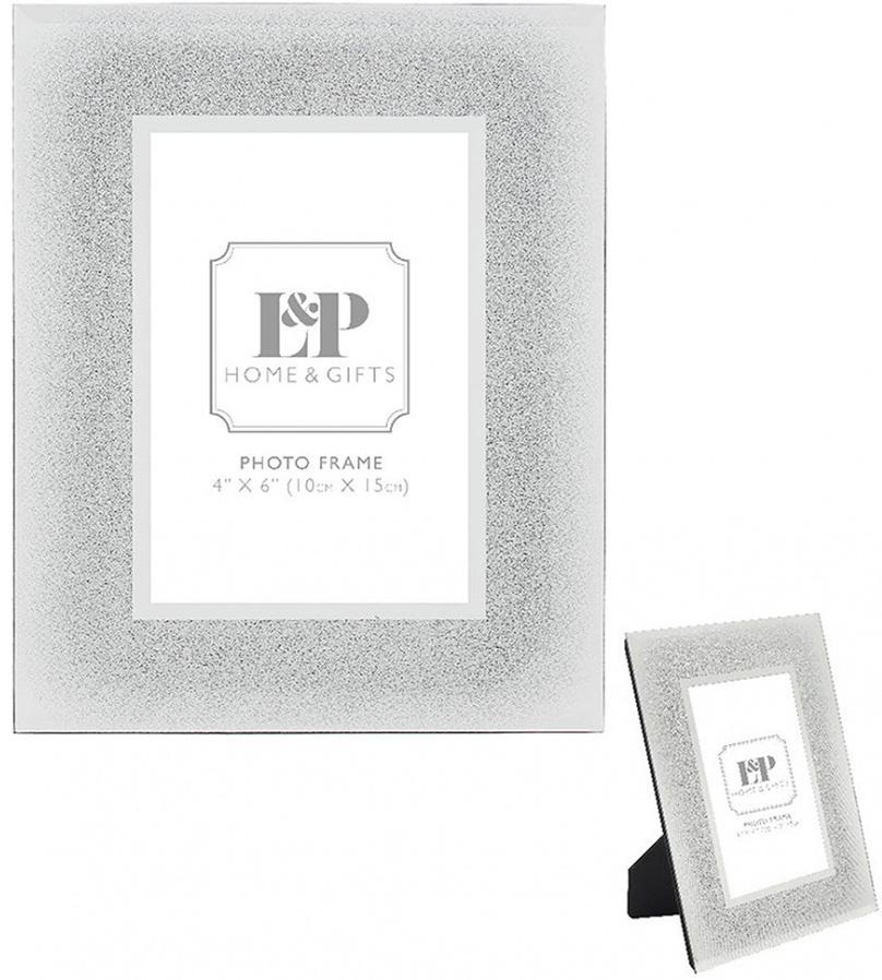 Vertical standing rectangular mirror and glittered wide rimmed photo frame.